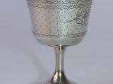 a silver cup that is sitting on a table