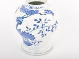 a blue and white vase sitting on a white surface