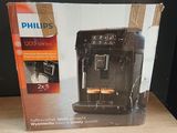 packaging of a coffee machine sitting on top of a wooden table