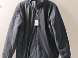 an image of a jacket hanging on a hanger on a wall