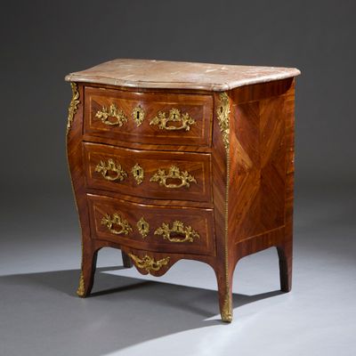 an antique chest of drawers with a marble top