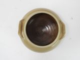 a brown bowl sitting on a table with a white background