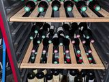many bottles of wine in a wine cooler in the kitchen