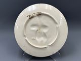 an image of a white plate with a gold decoration on it