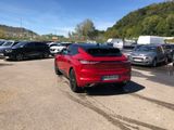 a red car that is parked in a parking lot