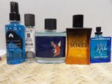 several different types of colognes are lined up on a table