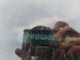 a reflection of a person holding a camera in front of a window