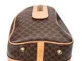 a close up of a brown and tan handbag on a white surface