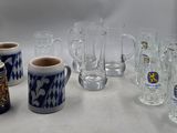 many glasses and mugs sitting on a table