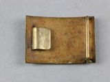 a gold buckle with a small square on top of it