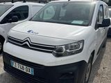 a white van parked in a parking lot next to other cars