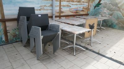 many chairs and tables in a room with a mural on the wall