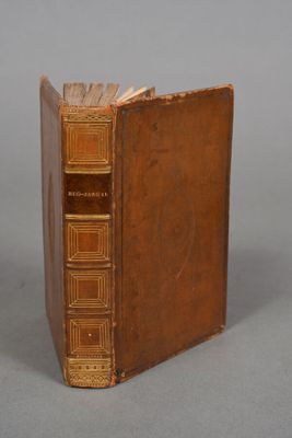 an old book sitting on top of a table next to a gray background