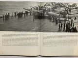 a book open to a picture of a large group of people on a boat