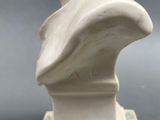 a white marble bust of a woman on a pedestal