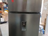 a silver refrigerator in the middle of a room