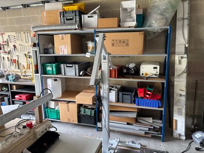 a work area with a work bench, shelves, and tools