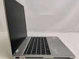 an open laptop computer sitting on top of a white surface
