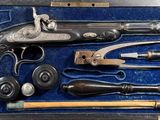 a case with a gun, hammer, knife and other items in it