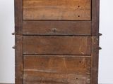 an old wooden chest of drawers on a tiled floor