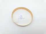 a white plate with a brown rim on a white surface