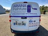 a white van parked in a parking lot next to a building