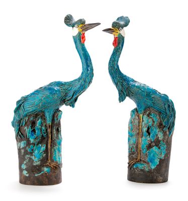 pair of blue and green bird sculptures on a white background