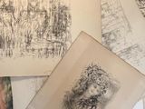 a pile of drawings on top of a table