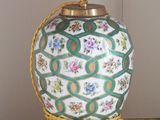 a lamp that is sitting on a table with a lamp shade on it