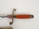 a knife that is laying on a table next to a knife