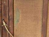 an old picture frame with a rope hanging from it ' s side