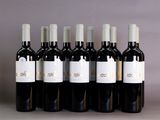 six bottles of wine are lined up in a row on a table