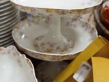 a lot of plates and bowls on the table