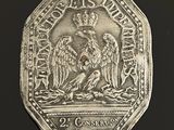 une pièce d'argent sur laquelle figurent deux hommes