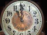 a clock that is sitting on a shelf in a room