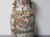 a large vase with a painting on it sitting on a table
