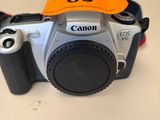 a small camera with a strap on it sitting on a table