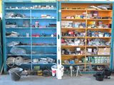 a blue cabinet filled with assorted items in a garage