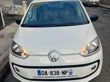 a white volkswagen up parked on the side of the road