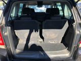 the back of a car with its trunk open and the back seats down