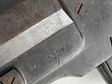 a close up of a gun on a white surface