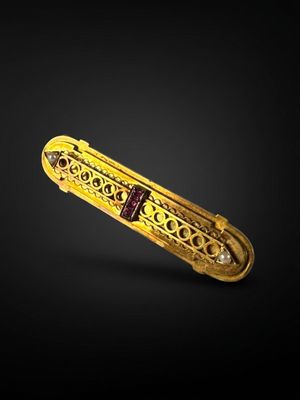 a gold and diamond pen with a red ribbon on a black background
