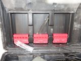 a black case that has a bunch of red boxes inside of it