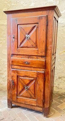 a wooden cabinet with a door on top of it