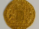 a close up of a gold coin on a white surface