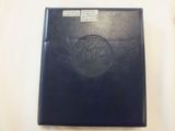 a close up of a black book with a picture of a ship on it