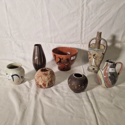 many different types of vases on a white surface