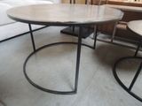 two tables that are sitting on the floor in a room