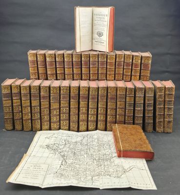 a pile of old books sitting on top of a table