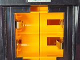 a black oven with a yellow shelf in it
